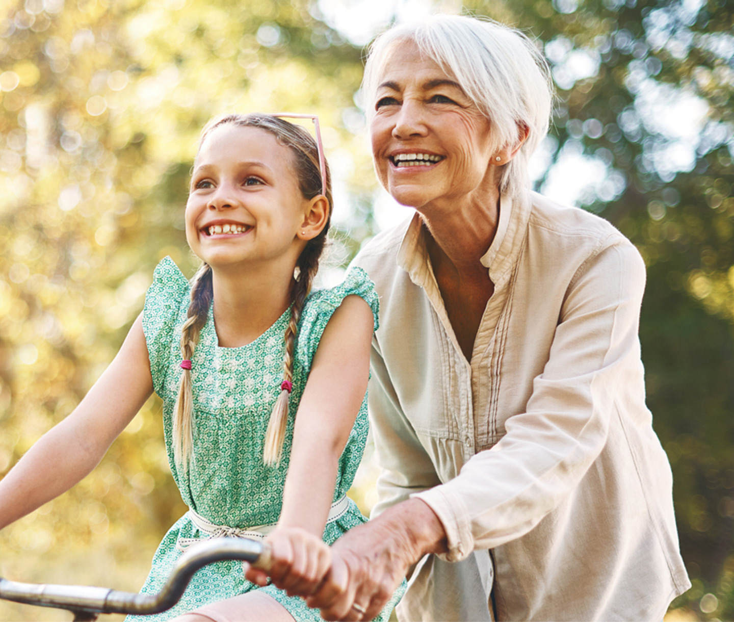 Grandmother teaching her Granddaughter to ride a bike